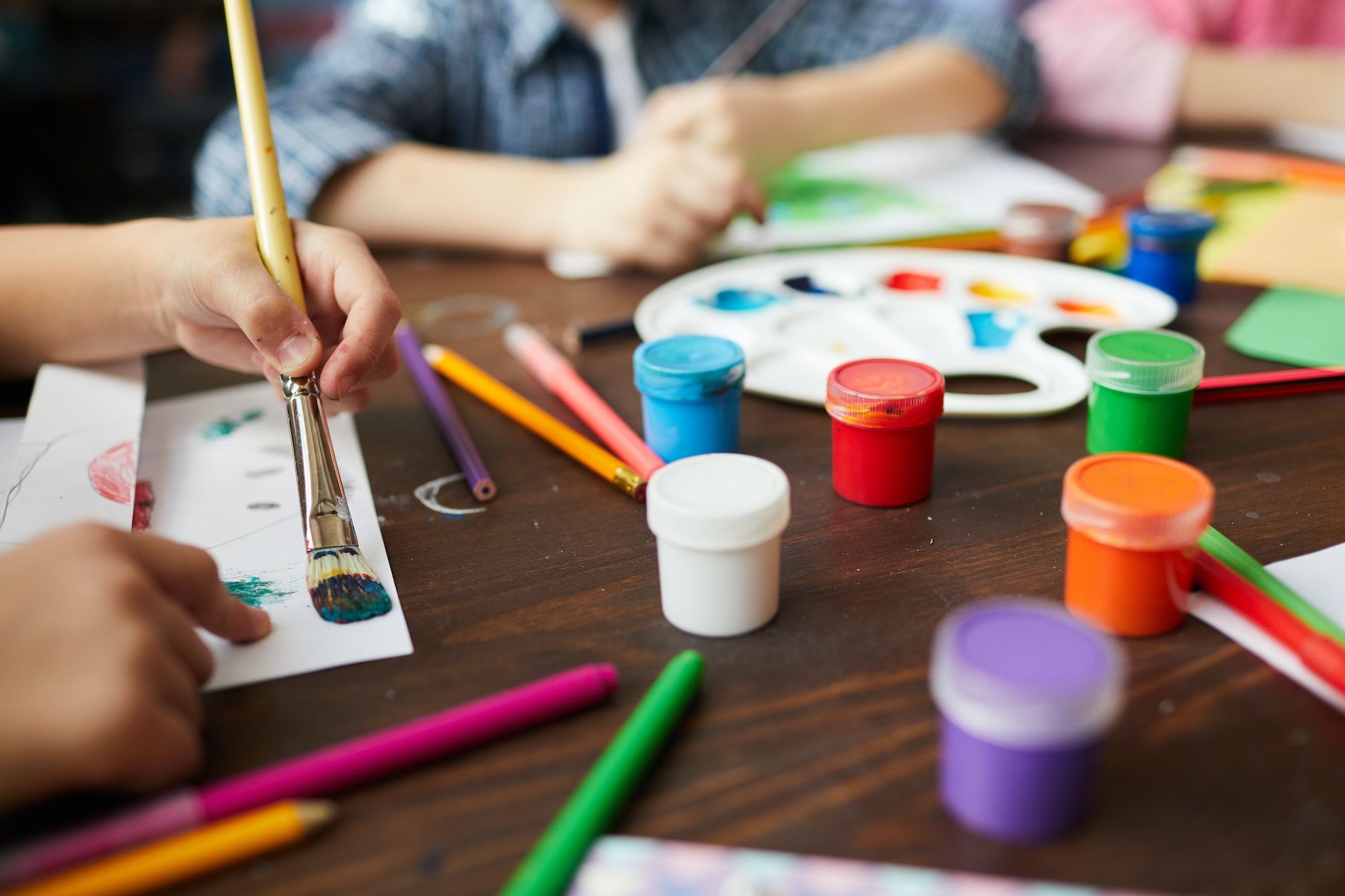 Closeup of Children Painting in Art Class